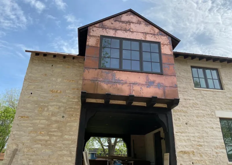 Copper metal panel facade on a stone building for Metal Roof Coating in Viera East