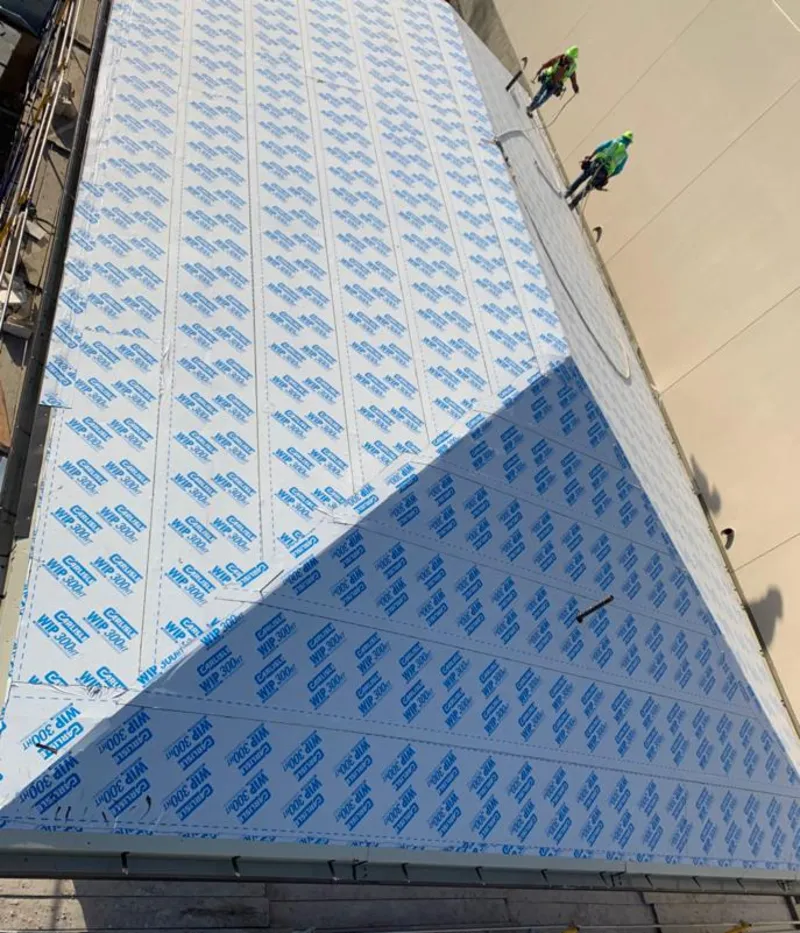 Professional roofers installing underlayment on a metal roof in Viera East